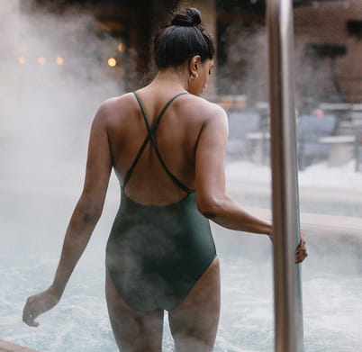 woman walking into hot tub