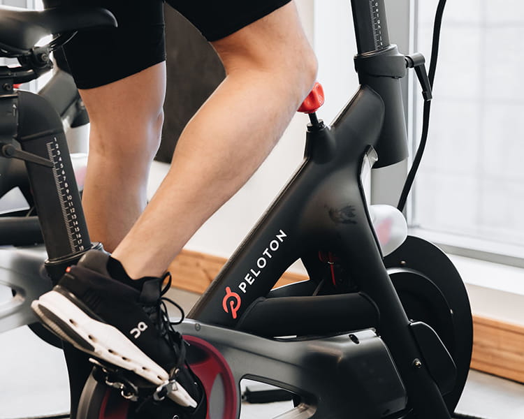 person using peloton bike