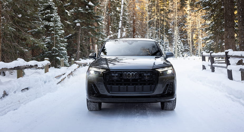 audi car driving in forest in winter