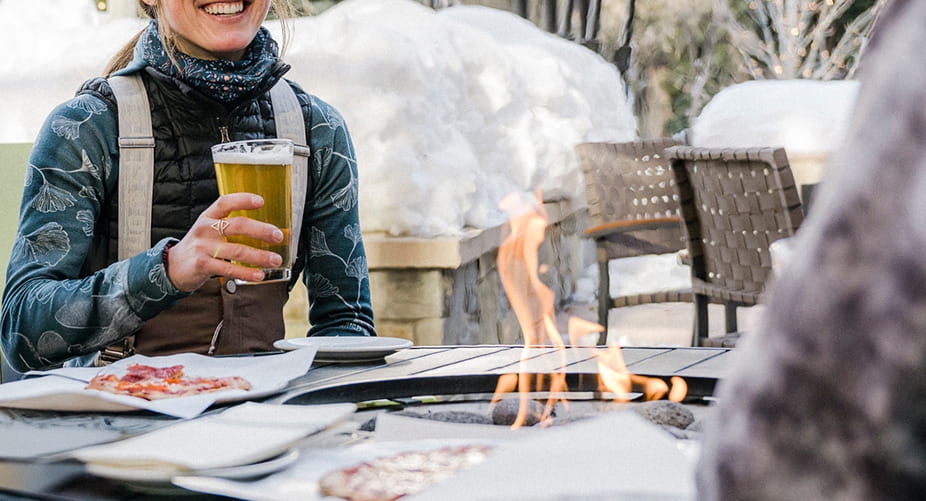 person having beer at outdoor firepit