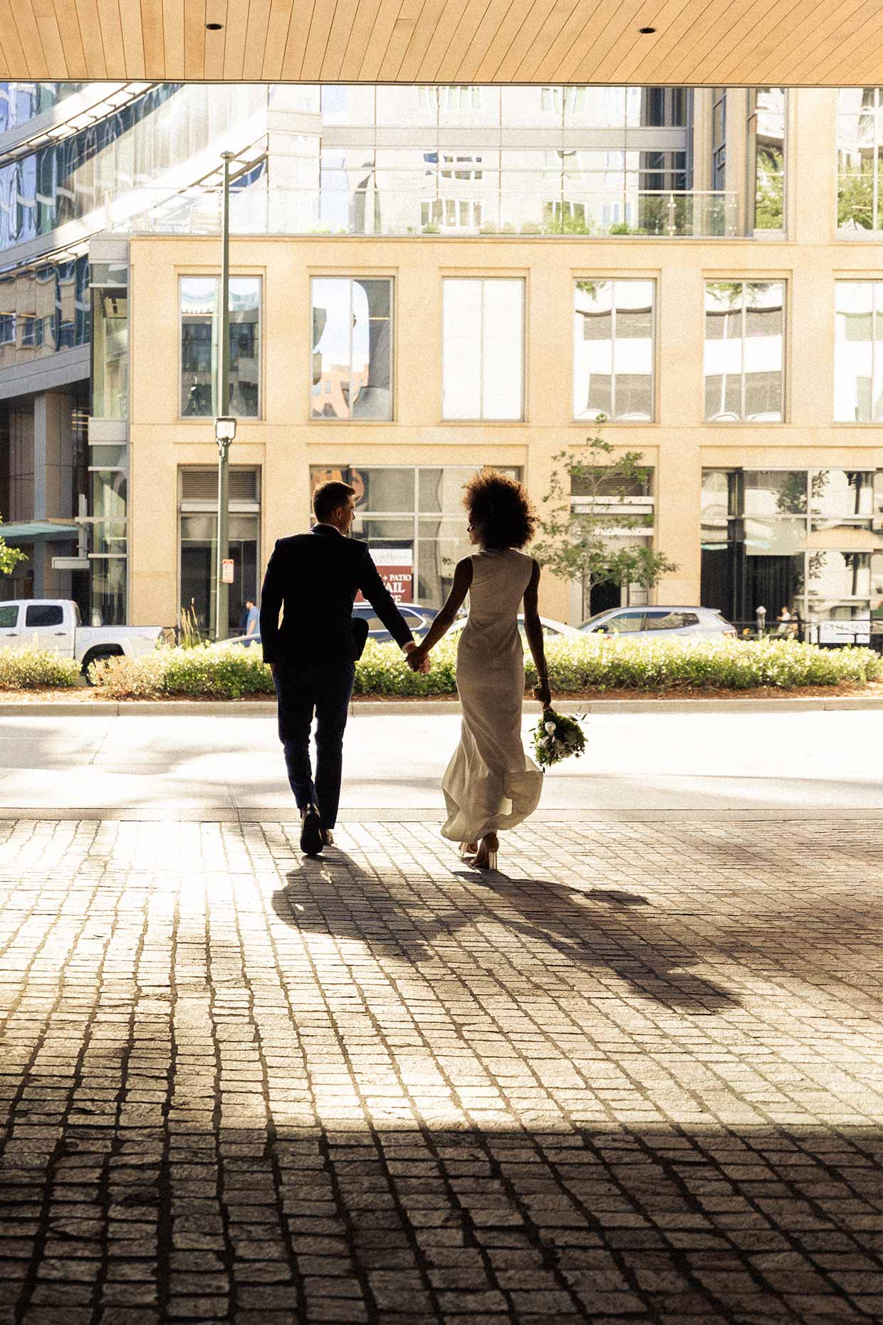 Married couple walking through Denver Porte Cochere