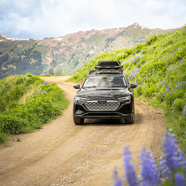 2024 Audi drives on dirt road outside aspen Snowmass, on overcast summer day