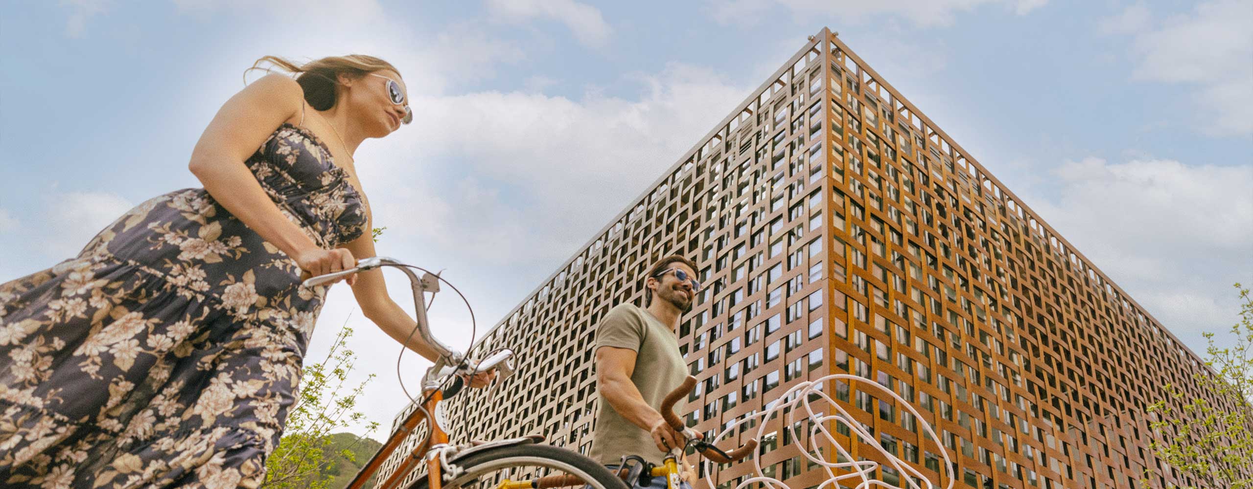 Couple biking by Aspen Art Museum